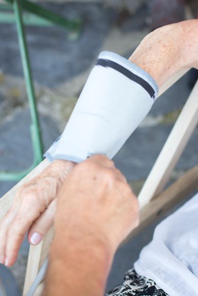 A doctor applying a plaster cast to a patient's fractured arm.